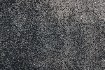 background of rough black asphalt surface with granular texture