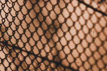 Background Shadow of a chain on a textured wall in sepia tones