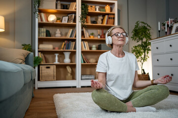 Mature woman enjoying a peaceful meditation with headphones