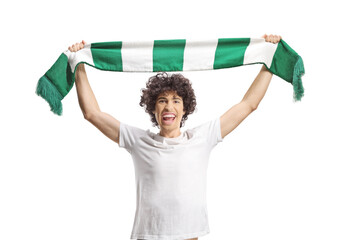Happy young male cheering with a green and white scarf