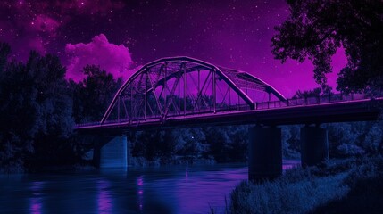 Fototapeta premium An illuminated bridge spans the flowing river at night