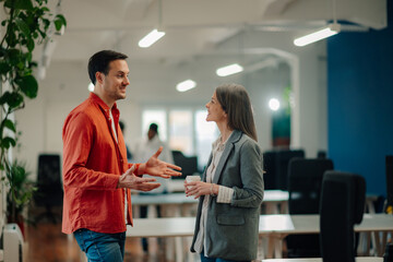 Business colleagues exchanging ideas during informal meeting in modern office
