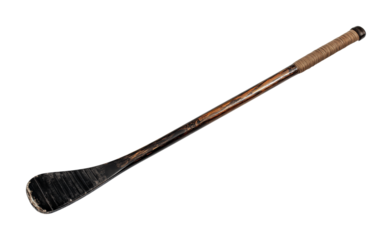 Vintage hurling stick with worn leather grip and distressed finish, cut out