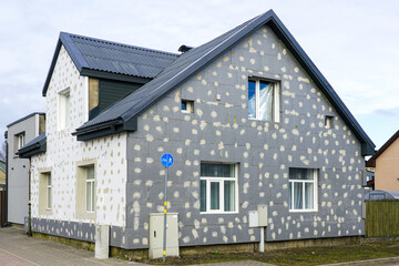 Thermal insulation of the facade of a residential building with thermal insulation material plates