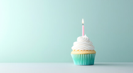 birthday cupcake with a candle on a pastel background banner,