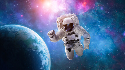 Astronaut in outer space over the planet Earth. Spaceman spacewalk. Orbit of Earth in deep space. Elements of this image furnished by NASA