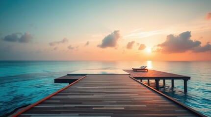 Obraz premium Tranquil sunrise over a pier extending into the ocean, promising relaxation and a serene escape.