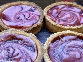 Indulge in our Delicious Swirled Berry Tarts, Freshly Baked to perfection and ready to enjoy. Indulge yourself in these beautifully striking berry tarts, featuring a delightful and intricate design