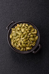 Peeled pumpkin seeds in a bowl, an ingredient for making vegetarian food