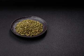 Peeled pumpkin seeds in a bowl, an ingredient for making vegetarian food