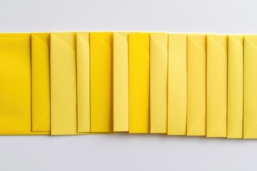 Vibrant yellow envelopes stacked on a minimalistic white surface