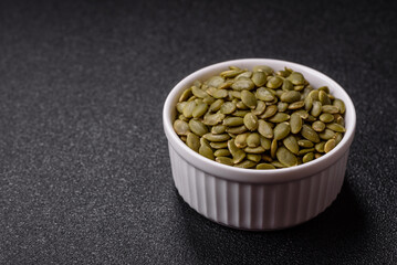 Peeled pumpkin seeds in a bowl, an ingredient for making vegetarian food
