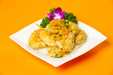 Golden crispy Jade Melon served in plate isolated on orange background side view of hong kong food