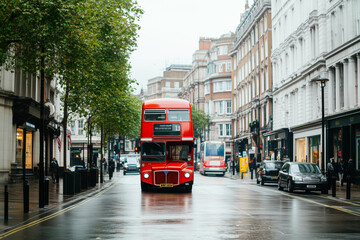 Iconic red double-decker bus on a rainy day in london street © Александра Ходорковс