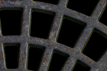 Close-up of rusted metal grates, showcasing their aged texture and intricate pattern of corrosion