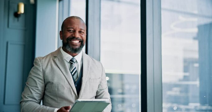 Tablet, communication and mature businessman by window in office with stock market development for investment. Digital technology, portrait and male financial manager with email for finance proposal.