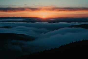 Obraz premium Sunrise over a mountain valley shrouded in clouds