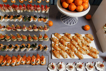 Buffet table with food and snacks for the guests of the event. Service at business meetings, weddings.