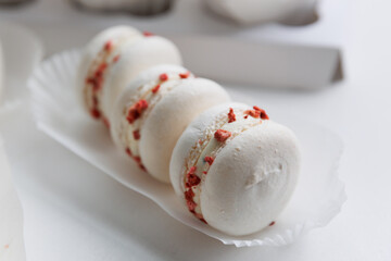 Dessert pasta. Sweet almond cookies with raspberries and cream on a white plate