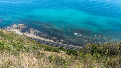 Street and Cliffs at Escarpment Track with crystal clear water, New Zealand