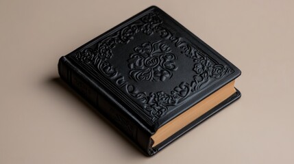 Fototapeta premium Elegant Embossed Black Leather Book with Ornate Floral Design