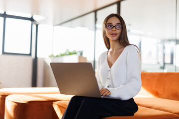 Young business woman having video call via laptop in the office