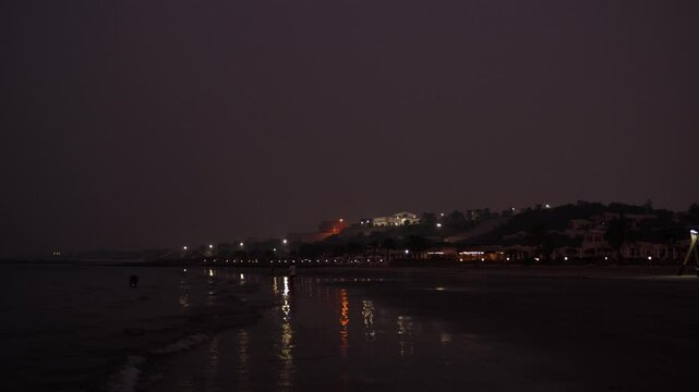 A Serene Night Beach Scene featuring an Enchantingly Illuminated Coastline at Dusk