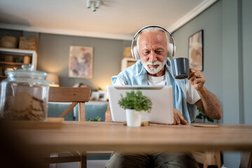 Senior man enjoying a relaxing morning with coffee and digital tablet