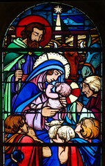 Fototapeta premium Stained glass (1930) of Christmas Nativity Scene with Virgin Mary, Saint Joseph, and Jesus baby.