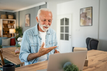 Senior man making a video call from home office