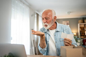 Fototapeta premium Senior man sending a kiss during a video call at home