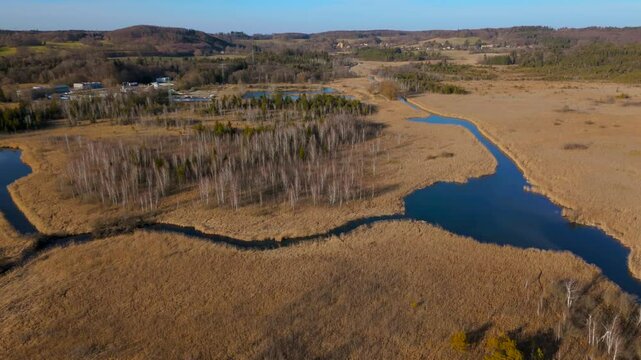 Aerial view of Upper Wurm River between Starnberg and Leutstetten, Bavaria. Clear water, wetlands, green meadows, and forests. Only outflow of Lake Starnberg, flowing through nature reserve in spring