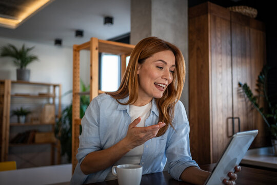 Businesswoman having a video call on a tablet in her home office