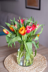 Bouquet of tulips in a glass vase in the living room