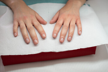 The master performs a manicure on the client