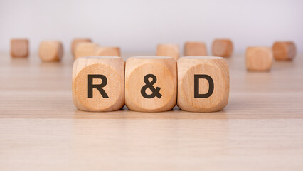 wooden blocks with text R and D on it. R and D stands for Research and Development