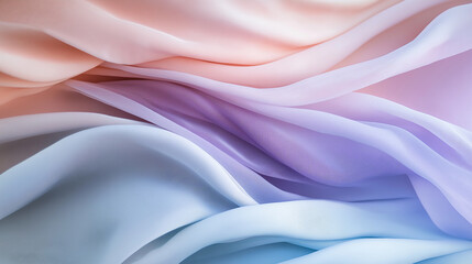 Obraz premium Soft flowing pastel fabric in shades of pink, blue, and lavender creating an elegant and dreamy abstract background.