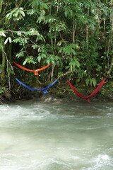 Vibrant Hammocks Hanging Over a Flowing River