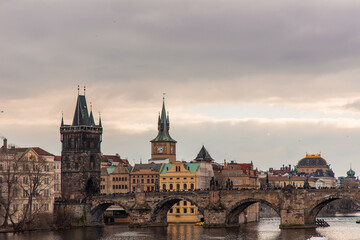 Naklejka premium Tourists walking on Charles Bridge in Prague with cloudy sky