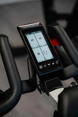 A black and silver exercise bike with a screen showing the time