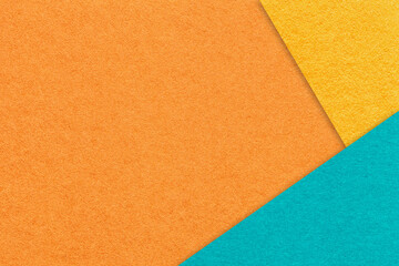 Texture craft orange paper background with yellow and turquoise border. Vintage abstract cerulean cardboard.