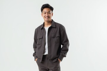 Fototapeta premium Half-Length (Waist-Up) portrait of young stylish smiling Indonesian male model in western wear isolated on pure white background looking at camera
