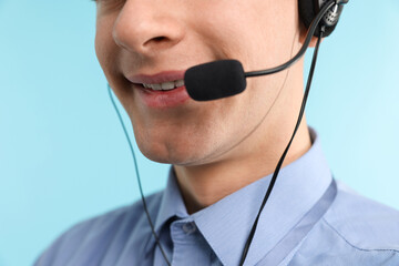 Technical support call center. Smiling operator on light blue background