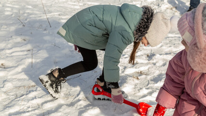 Playful family enjoying snowball fight in snowy winter park