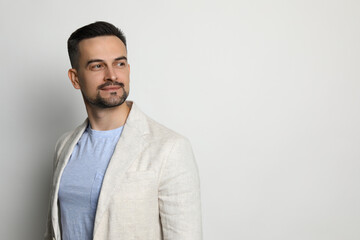 Portrait of handsome middle aged man on light background, space for text