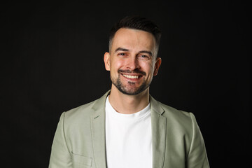 Obraz premium Portrait of handsome middle aged man on black background