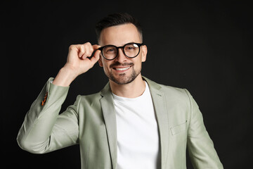 Obraz premium Portrait of handsome middle aged man on black background