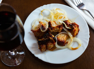 Delicious pork shish kebab with onions on a plate in a georgian restaurant