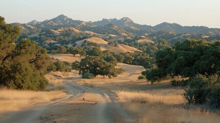 A beautiful view of rolling hills and mountains under a clear sky.