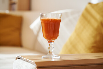 Fresh carrot juice indoors in an apartment